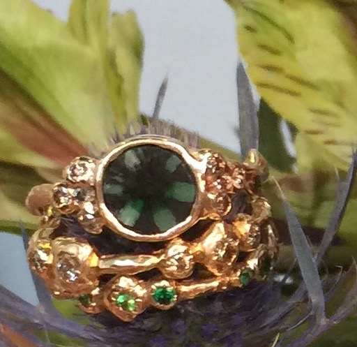 The Eden Collective Emerald ring and stack rings with hematoid garnets, diamonds and sapphires
